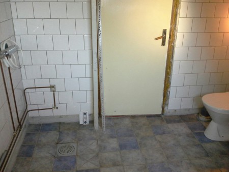 Dörr till källaren med utrymme för snickarbänk, tvättmaskin och frysbox